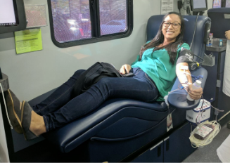 Photo of female RBA employee donating blood