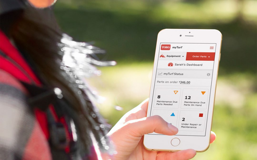 Picture of a woman looking at the Toro myTurf mobile app